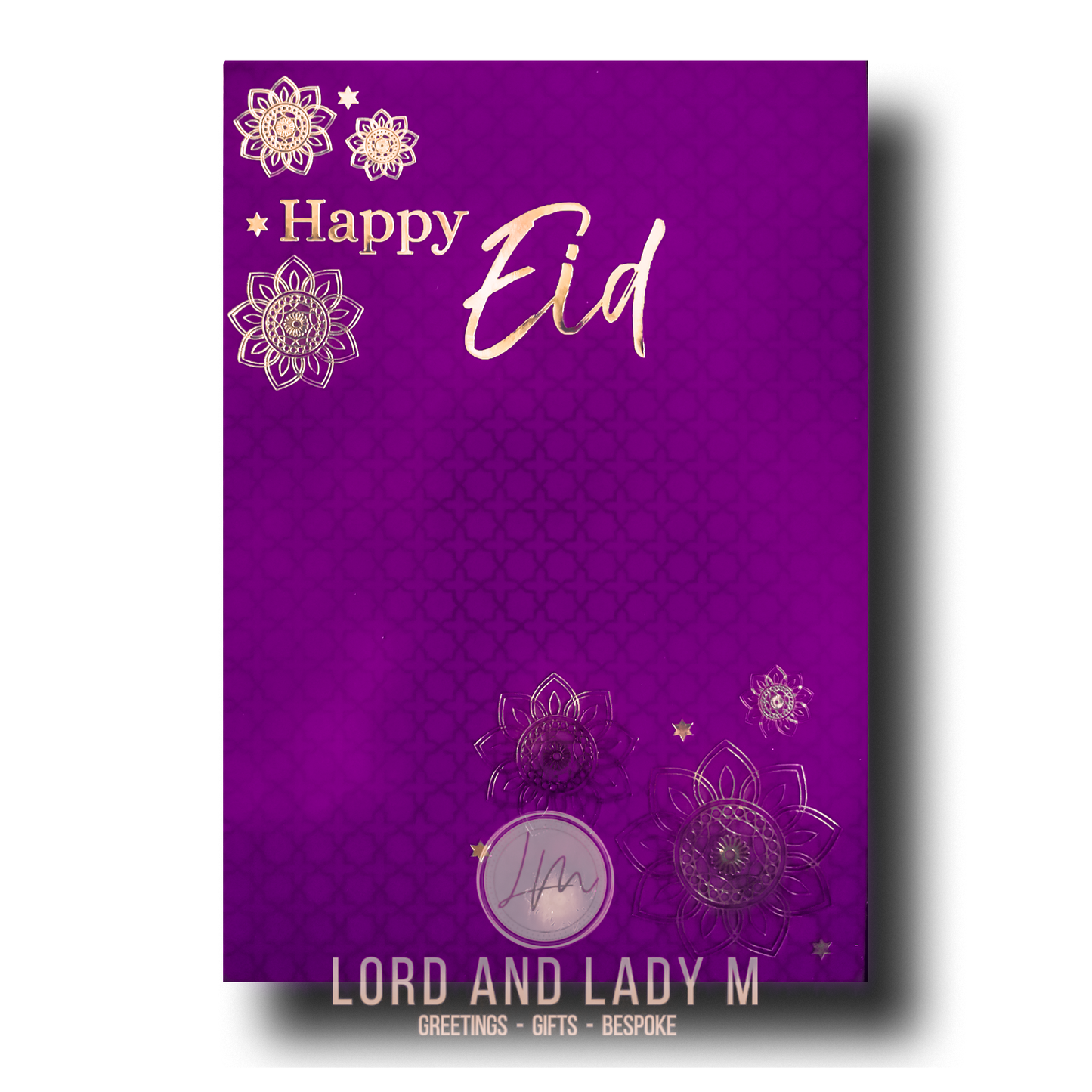 A purple greeting card with 'Happy Eid' written in gold, featuring gold floral designs around the text.