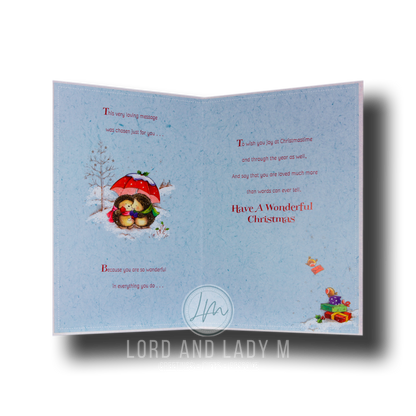 Full image of the open Christmas card with printed blue insert featuring a verse over 2 pages and hedgehogs.